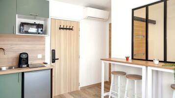 Fridge, microwave, coffee/tea maker, cookware/dishes/utensils