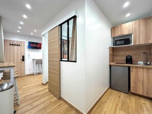 Fridge, microwave, coffee/tea maker, cookware/dishes/utensils