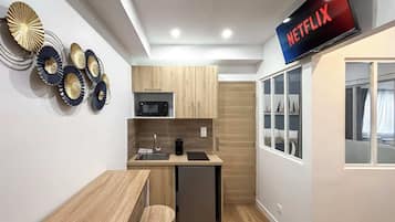 Fridge, microwave, coffee/tea maker, cookware/dishes/utensils