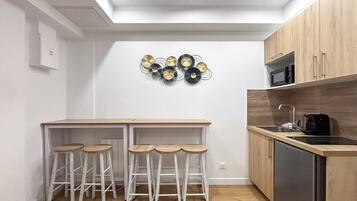 Fridge, microwave, coffee/tea maker, cookware/dishes/utensils