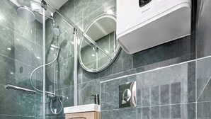 Ein modernes Badezimmer mit einer Duschkabine, einer Toilette und einem Bidet.