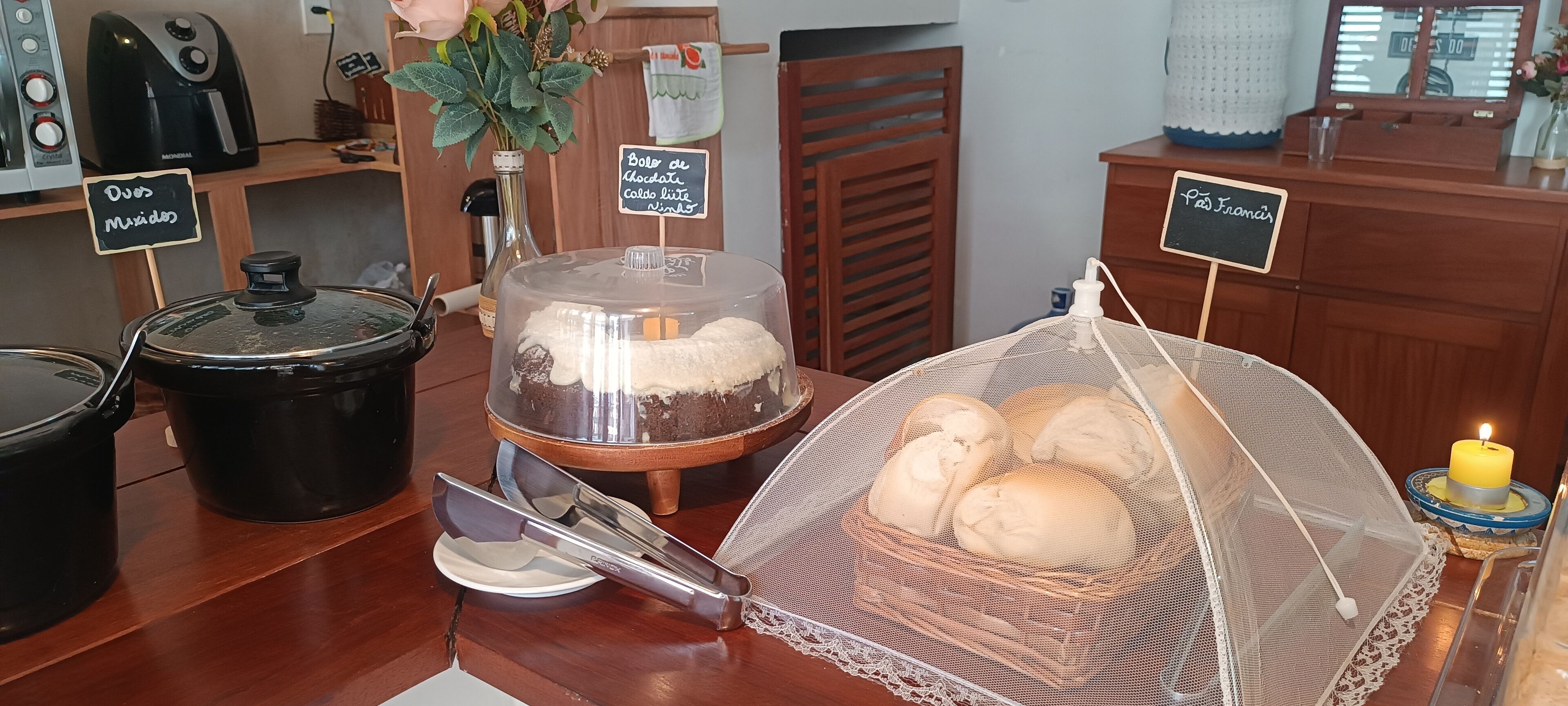 A kitchen area with a bread display, a cake, and a candle.