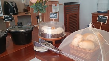 A kitchen area with a bread display, a cake, and a candle.