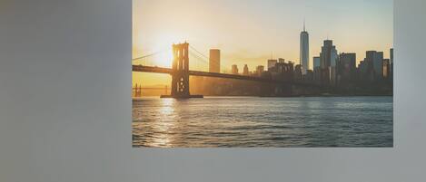 A framed cityscape with a bridge and buildings.