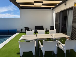 An outdoor patio with a pool, white chairs, a table, and a grill. - Fuerteventura Velvet Golf Holiday Home with Private Pool, Wi-Fi & Air Conditioning (Antigua)