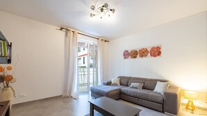 A modern living room with a sectional sofa, a coffee table, and a lamp.