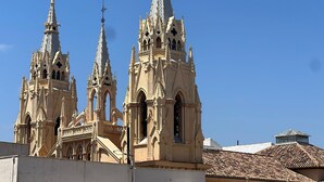 A historic church with three tall spires and intricate architectural details.