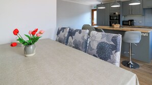 A modern kitchen with grey cabinets, a microwave, and a toaster. - Fircroft (Perth)
