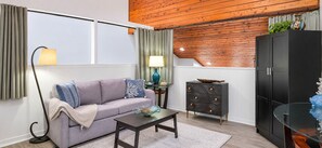 A living room with a sofa, coffee table, and a cabinet.