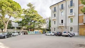 A multi-story building with a parking lot in front. - Suite 53 Campofiore - with outdoor patio (Verona)