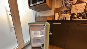 A kitchen with a refrigerator, a coffee machine, and a microwave. - NEW! Apartment Engel (Weilburg)