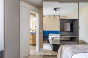 A modern hotel room with a bed, a desk, and a wardrobe. -  1 Bedroom Apartment with pool 600m from Moema/SP metro station NPZ093 (São Paulo)