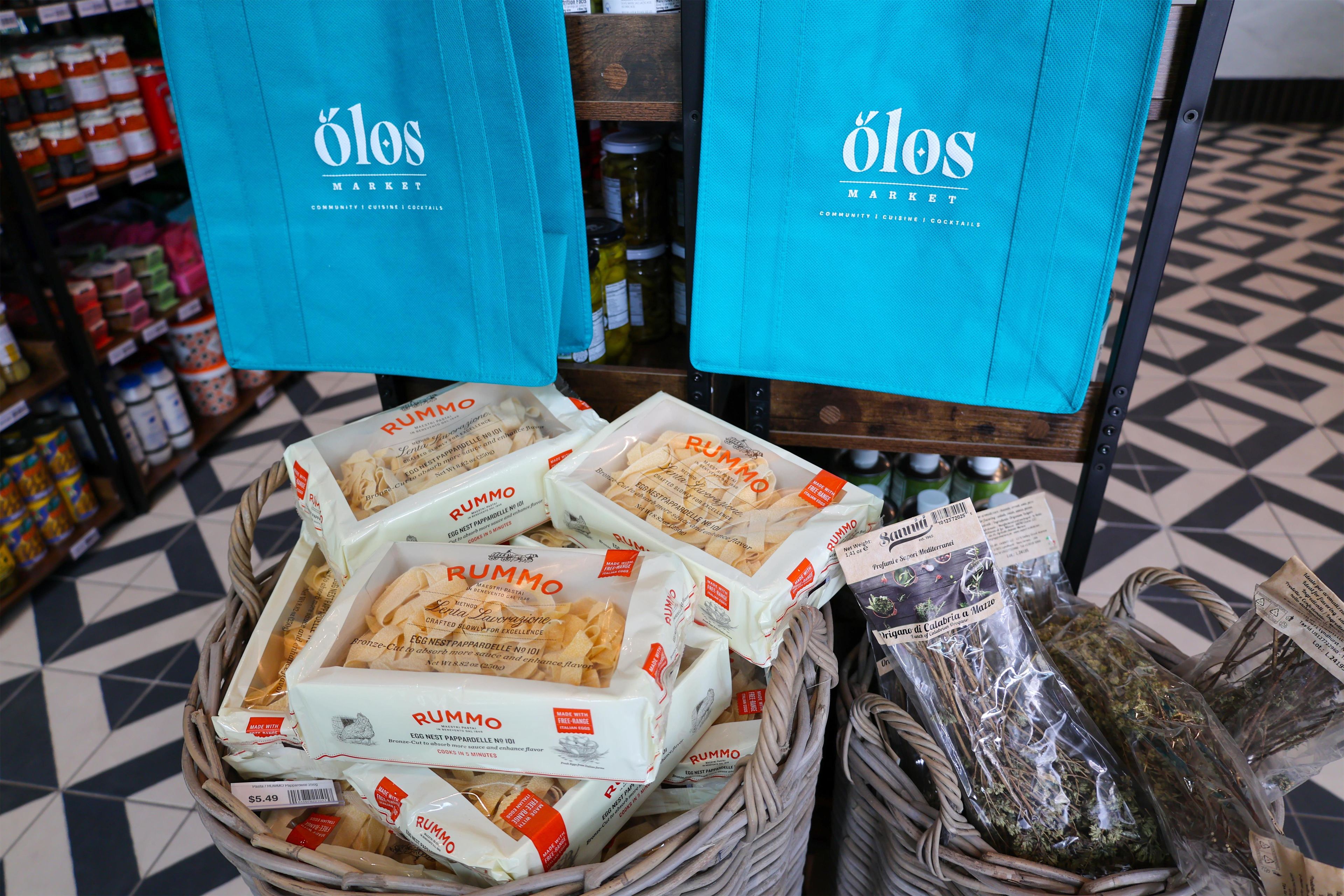 Un panier contenant des produits alimentaires emballés, portant la mention « RUMMO », est exposé sur une étagère dans un magasin.