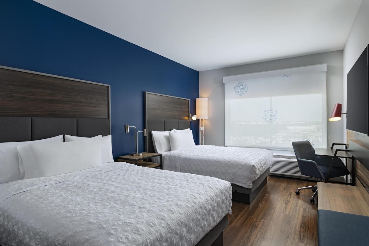 Premium bedding, desk, laptop workspace, blackout curtains
