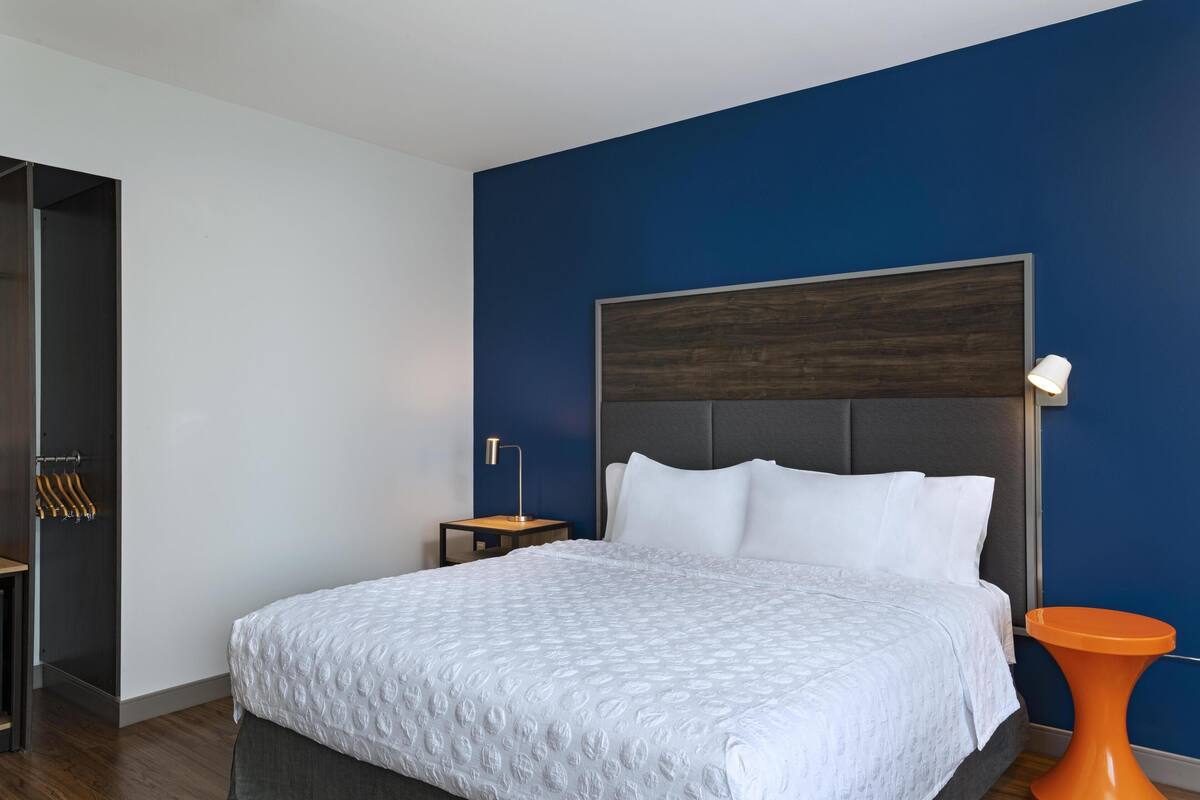 Premium bedding, desk, laptop workspace, blackout curtains