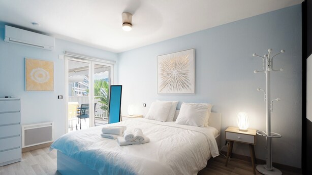 A modern bedroom with a bed, bedside tables, a nightstand, and a floor lamp.