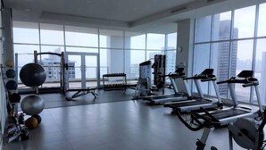 A gym with treadmills, weight machines, and exercise balls. - Pacific Cafe Classy 1-bedroom in Costa del Este (Panama City)