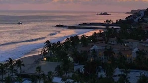 A coastal resort with a view of the ocean and a sunset.