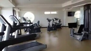 A gym with treadmills, stationary bikes, and weight machines.