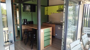 A modern kitchen with green cabinets, a wooden countertop, and a built-in dishwasher. - Superb Portland Chalet, 3 bedrooms, sleeps up to 7, all comforts (Évron)