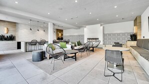 A modern kitchen with a central island, a dining area with chairs, and a seating area with a sofa. - nr Downtown San Diego & Shops | Pet-friendly 1BR in Mission valley (San Diego)