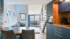 A modern kitchen with a wooden countertop, built-in cabinets, and a view to the outside. - Mini-duplex NOLEMMA (Deauville) (Deauville)