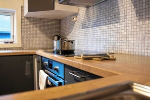 Fridge, dishwasher, coffee/tea maker, cookware/dishes/utensils