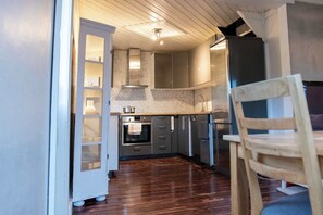Fridge, dishwasher, coffee/tea maker, cookware/dishes/utensils