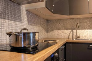 Fridge, dishwasher, coffee/tea maker, cookware/dishes/utensils