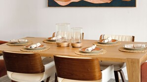 A dining table set with clear glass candle holders, white napkins, and wooden chairs. - Sedona Retreat • Newly Renovated 3BR Home - Amazing Views (Sedona)