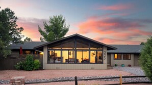 A modern house with a large glass windowed porch, a brick entryway, and a number 325 on the side. - Sedona Retreat • Newly Renovated 3BR Home - Amazing Views (Sedona)