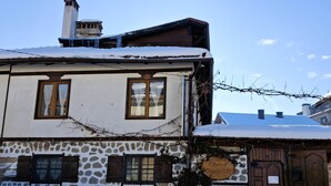 A traditional stone building with a wooden door and a sign that reads "Chalet Garibaldi." - Marvelous 8-bedroom catered ski chalet in Bansko with Total Chalets (Bansko)