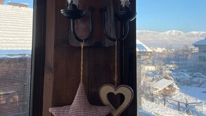 A wooden wall with two wall-mounted sconces and a star-shaped decoration hanging below them. - Marvelous 8-bedroom catered ski chalet in Bansko with Total Chalets (Bansko)