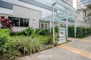 A modern building with a glass entrance and a sign that reads "601 ANTIQ." - Modern Comfort With Pool in Sao Paulo You1203 (São Paulo)