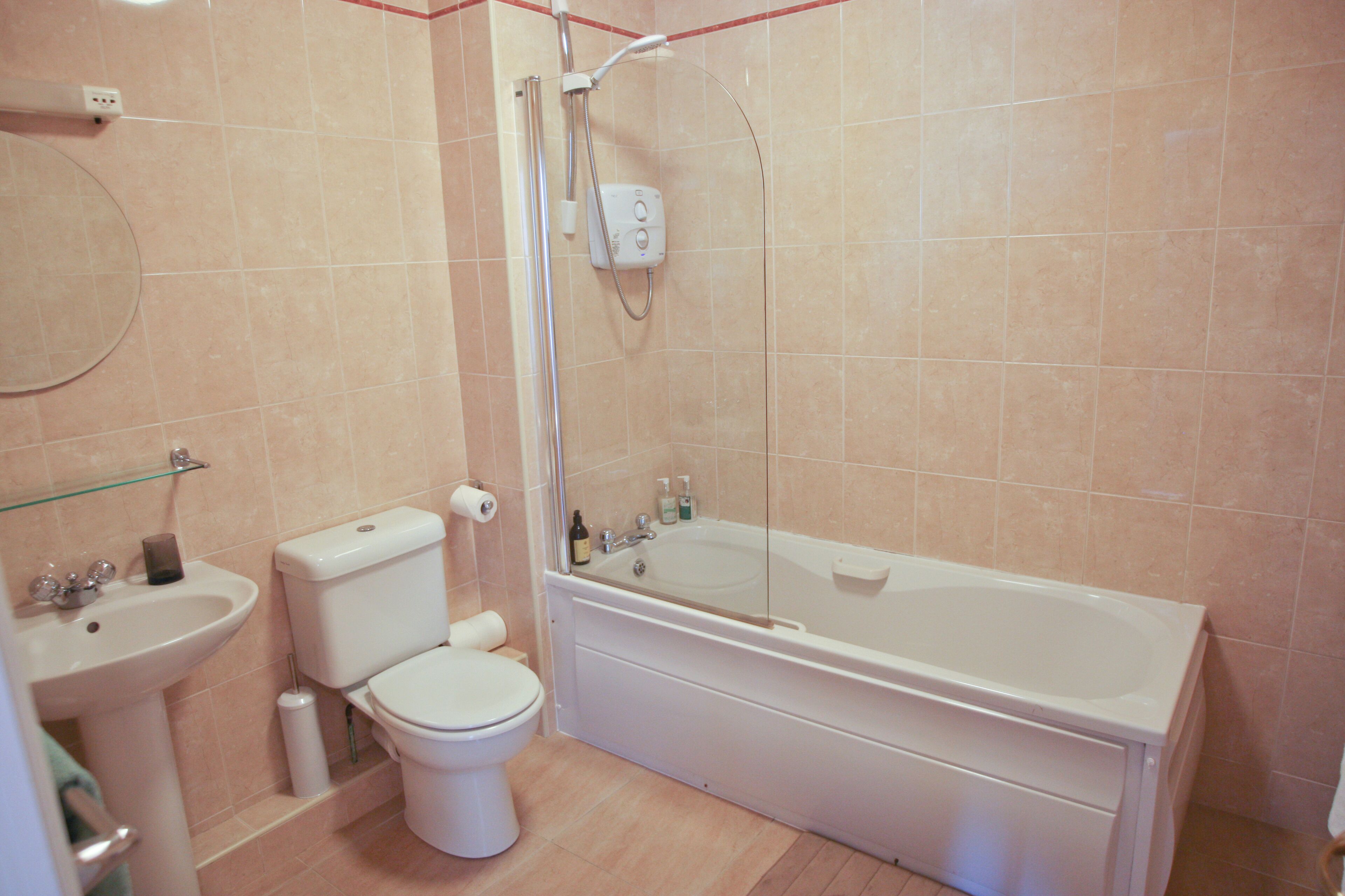 A bathroom with a toilet, sink, and bathtub.
