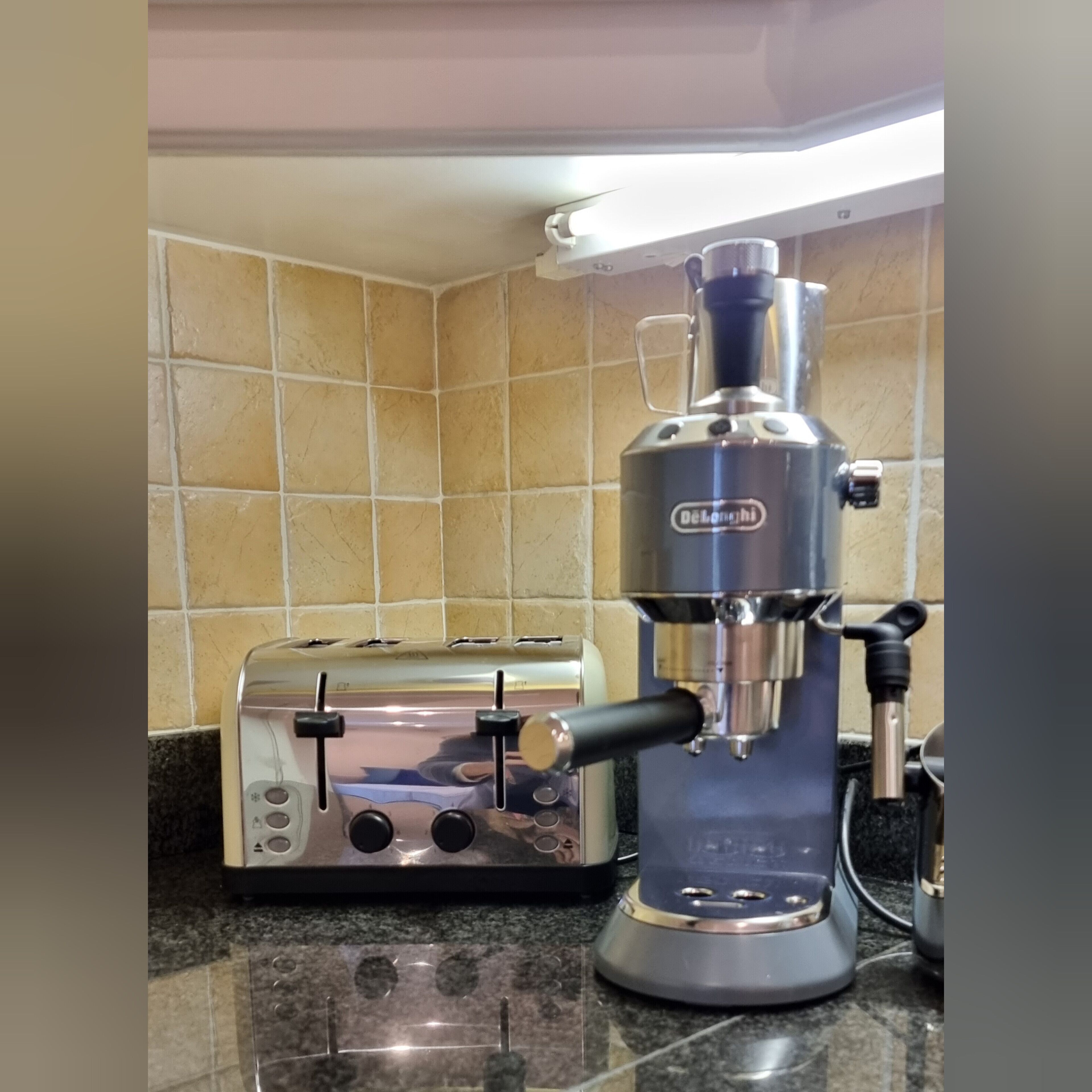 A kitchen with a toaster and a coffee maker on the counter.