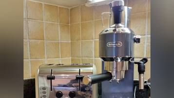 A kitchen with a toaster and a coffee maker on the counter.