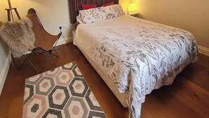 A bedroom with a bed, a headboard, a lamp, a rug, and a fur throw. - Clarin Rest, luxury private room, Clarinbridge Wild Atlantic Way, Galway. (Co Galway)
