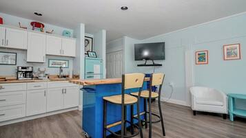 Fridge, microwave, coffee/tea maker, cookware/dishes/utensils