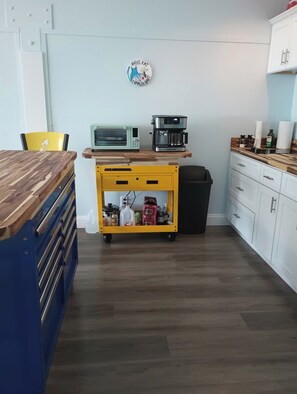 Fridge, microwave, coffee/tea maker, cookware/dishes/utensils