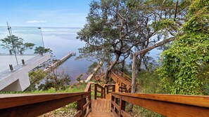 A wooden staircase leading to a viewpoint overlooking a body of water.