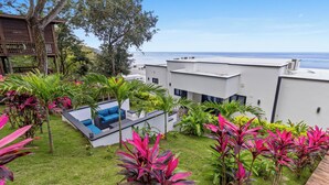 A modern outdoor area with a pool, seating, and lush greenery. - Oceanfront Villa w/ Infinity Pool, 2 Casitas w/ Plunge Pools, Dock, Concierge (Punta Blanca)