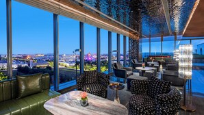 A modern lounge with large windows, comfortable seating, and a view of the cityscape. - Crowne Plaza Beijing Tongzhou by IHG (Tongzhou)