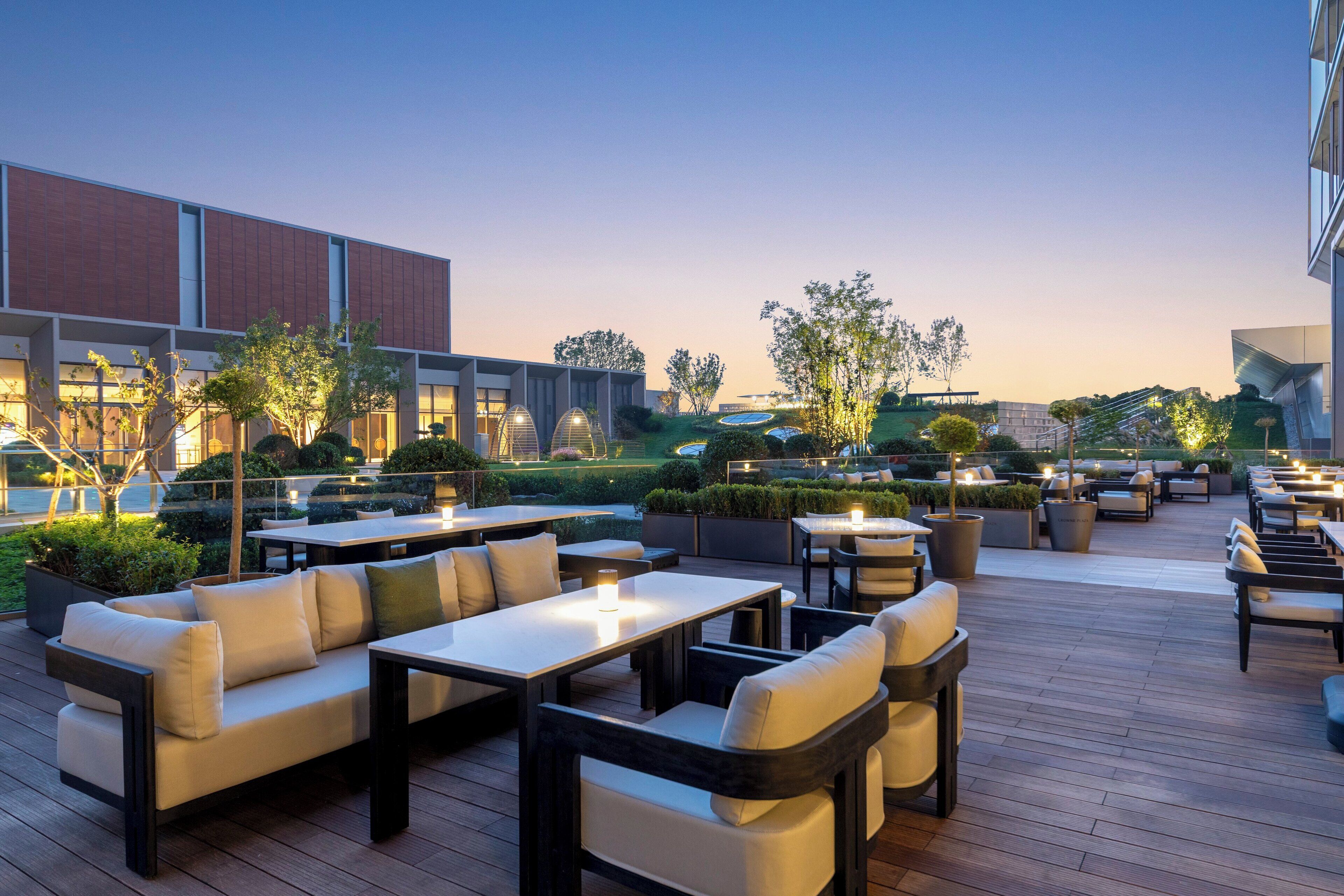 An outdoor patio area with seating arrangements and a view of the surrounding buildings.