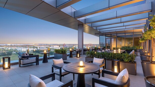 A rooftop terrace with outdoor seating, potted plants, and a view of the cityscape. - Crowne Plaza Beijing Tongzhou by IHG (Tongzhou)