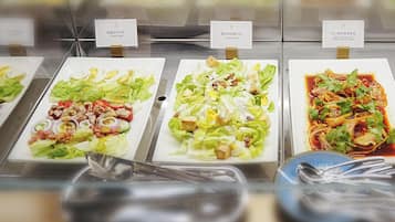 A buffet with various dishes including salads and a spicy dish.