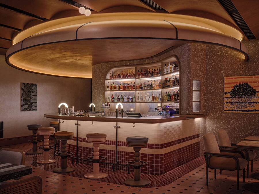 A bar area with a curved counter, stools, and a tiled floor.