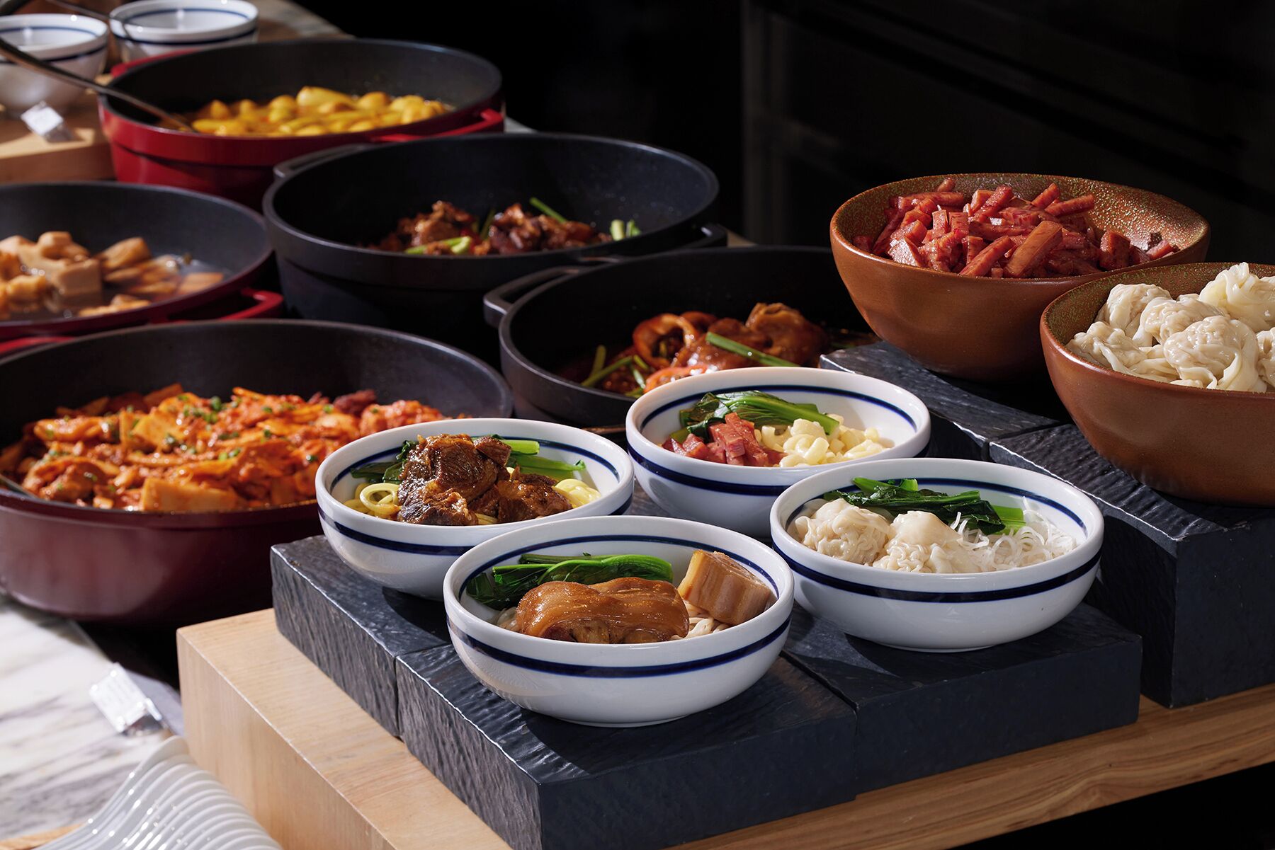 A variety of dishes in bowls and pots, suggesting a meal setting.