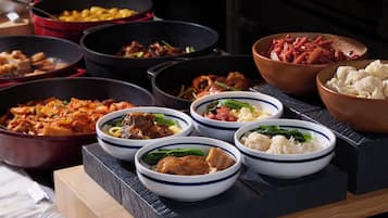A variety of dishes in bowls and pots, suggesting a meal setting.