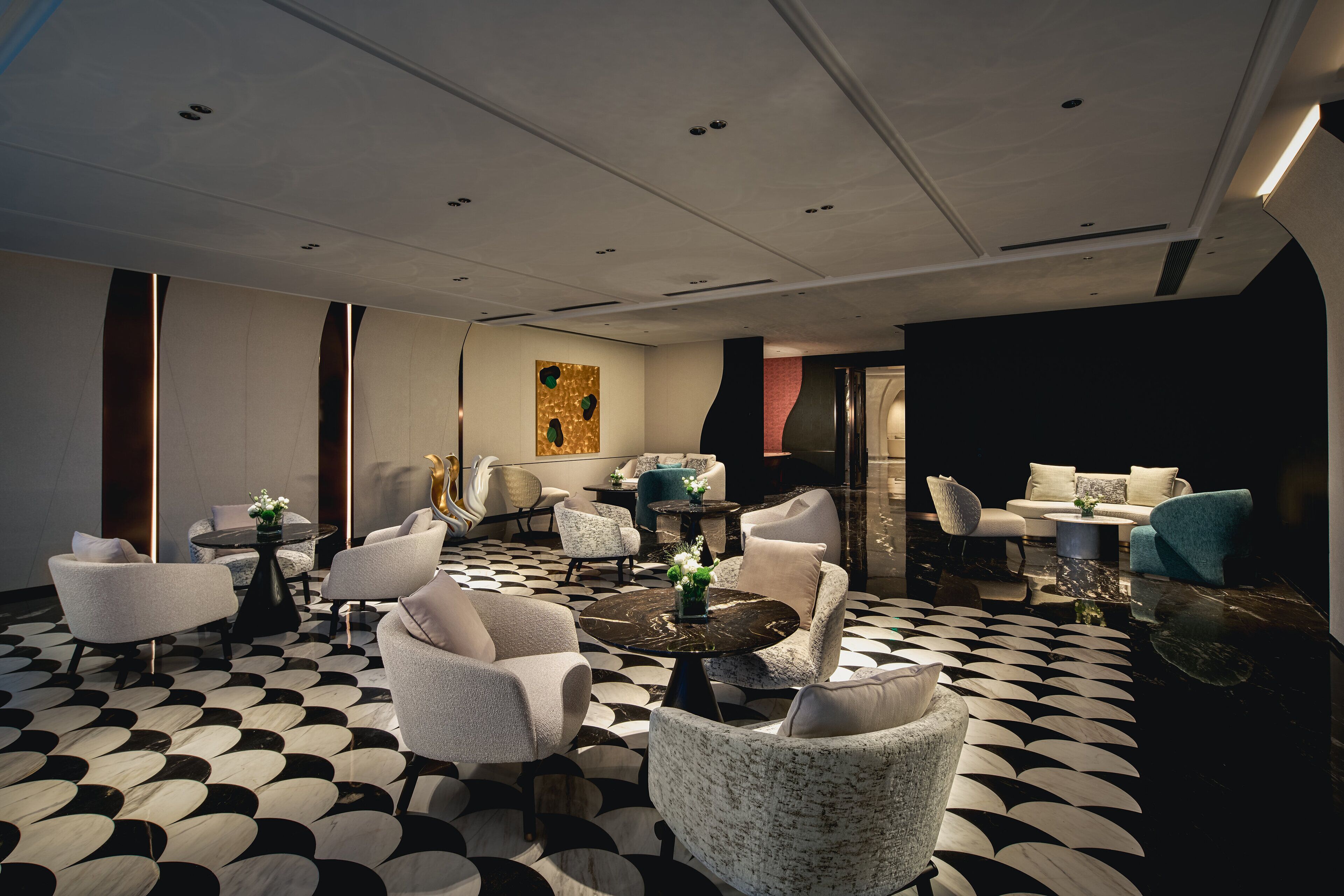 A modern lounge area with a checkered floor, multiple seating options including sofas and armchairs, and a central coffee table.